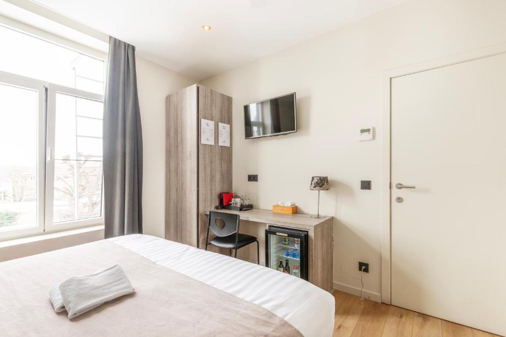 Postel nebo postele na pokoji v ubytování Hotel Het Menneke