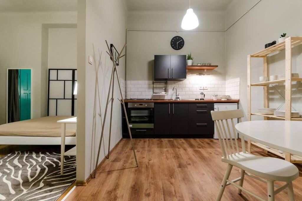 a room with a kitchen and a dining room at Cosy Apartment In Party District K30 in Budapest