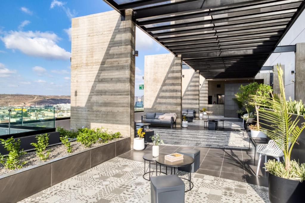 an outdoor patio with furniture and plants on a building at Downtown Loft by ULIV in Tijuana