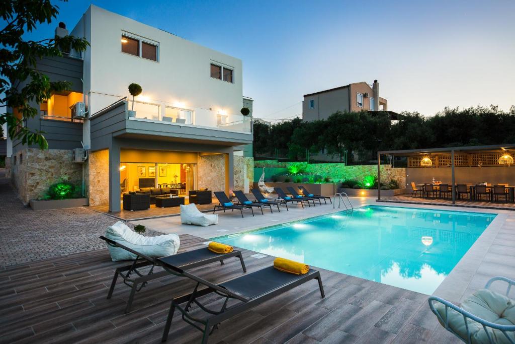 a backyard with a pool and a house at Villa Aelia I Modern & Ideal for large groups in Galatás