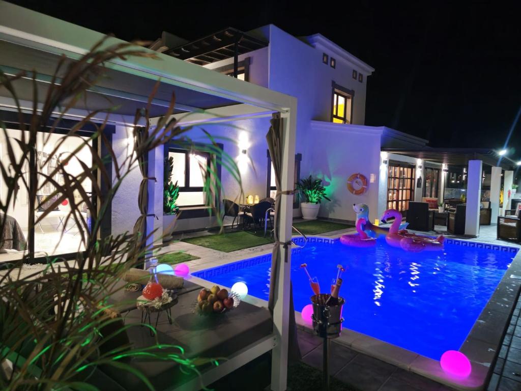 a house with a swimming pool at night at VILLA KARLA in Playa Blanca