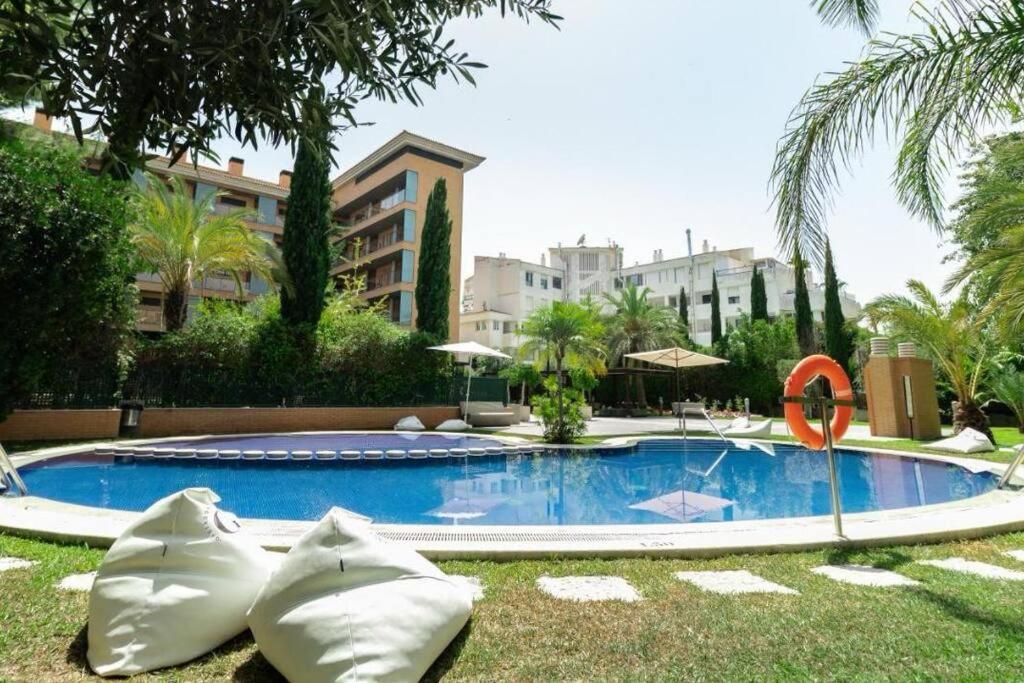 a large swimming pool in the middle of a resort at Ibo beach apartment Albir in Albir