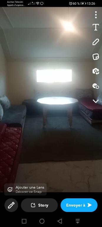 uma imagem de um quarto com um sofá e uma luz em Arêches em El Hajeb