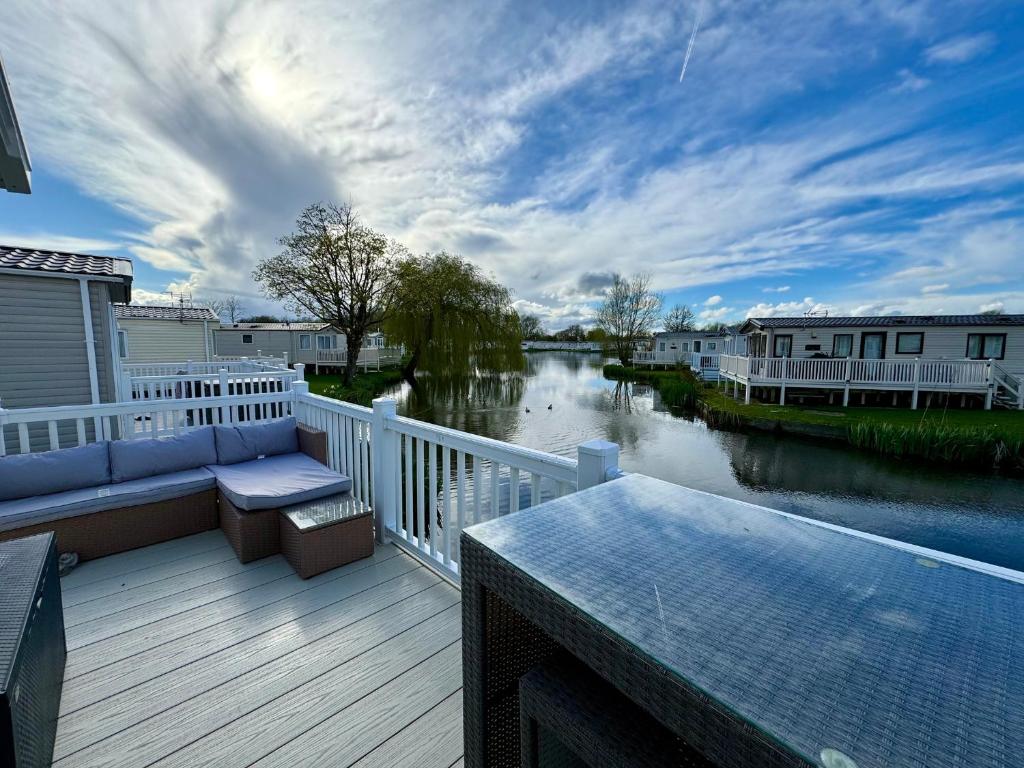 a balcony with a view of a river at Drakes View Dog friendly chalet in South Cerney