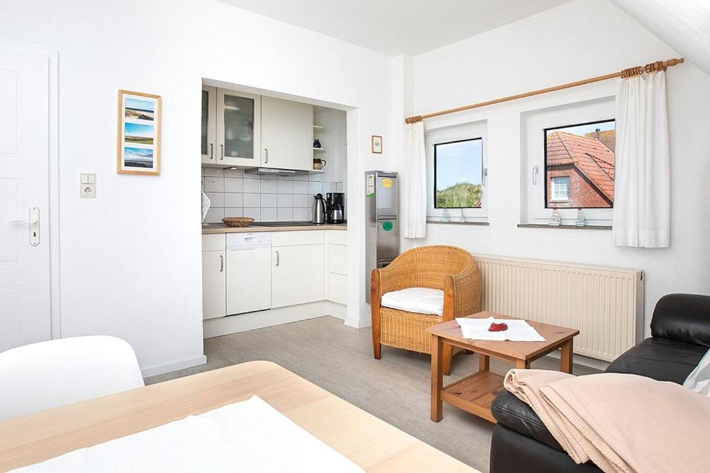 a living room with a couch and a table at Haus Delphin in Juist