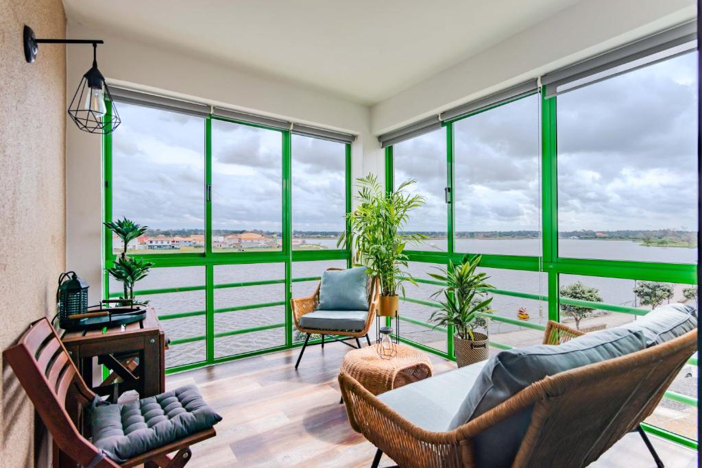 a living room with a view of the water at Bela Vista Barrinha in Praia de Mira