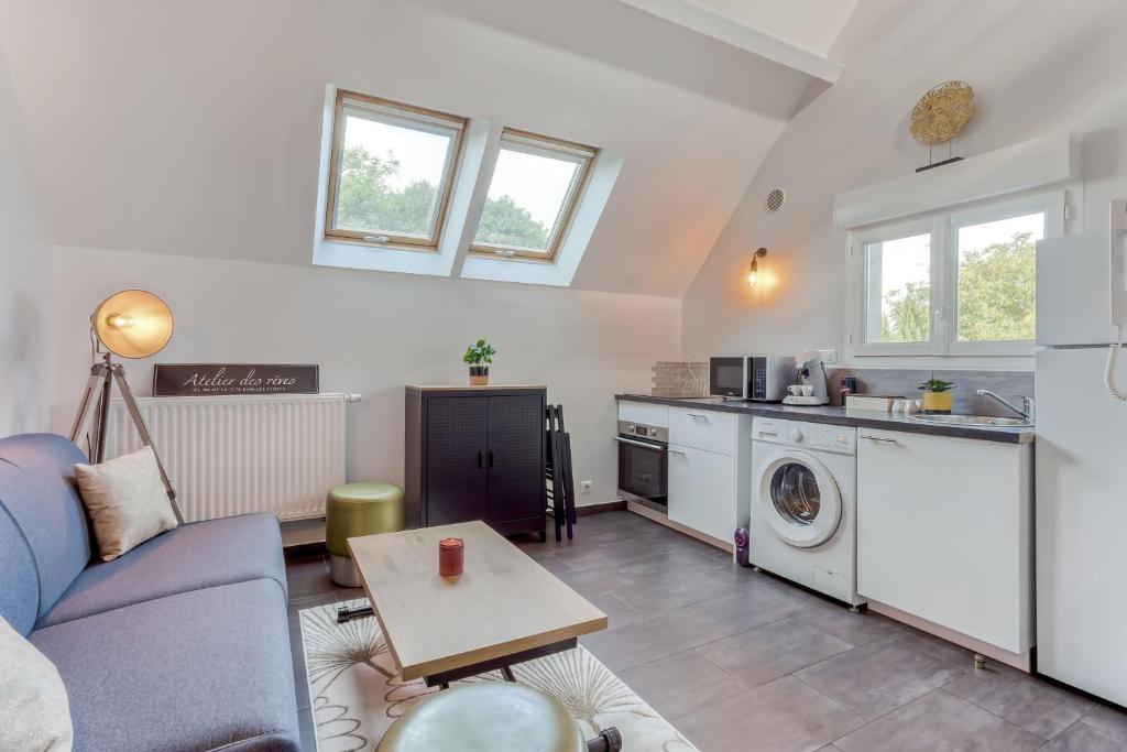 a living room with a couch and a table at Duplex Moderne à Chennevières in Chennevières-sur-Marne