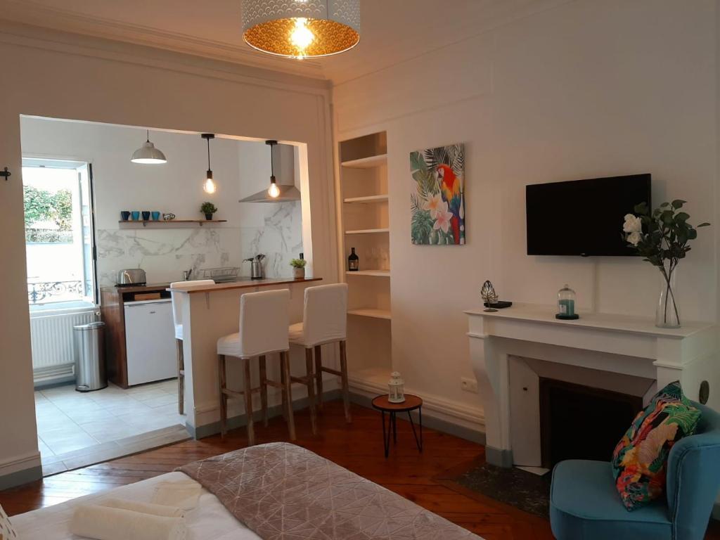 un salon avec cheminée et une cuisine dans l'établissement Amazonia Rouen Centre by MyFrenchPAT, à Rouen