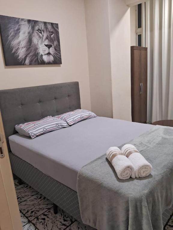 a bedroom with a bed with two towels on it at Coração do Rio de Janeiro in Rio de Janeiro