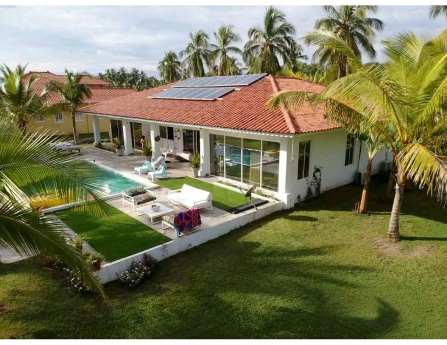 an aerial view of a house with a solar roof at Casa Carey Lajas Pty Exclusive Beachfront Villa in Cabrera