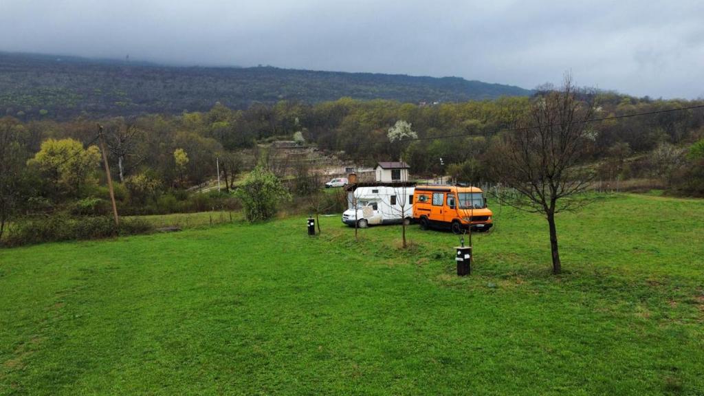 a van parked in a field in a field at Auto camp Matica in Podgorica