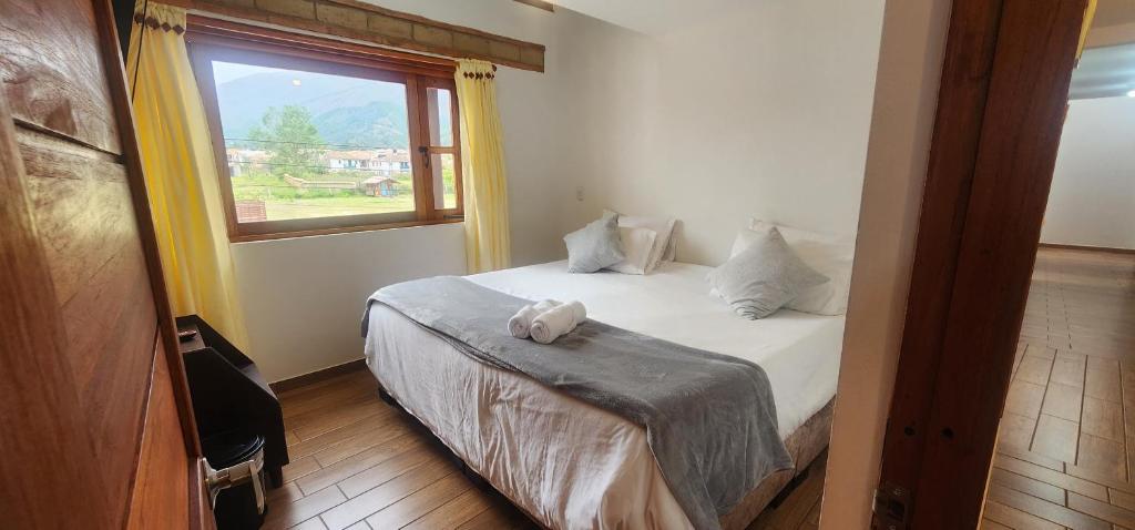 een slaapkamer met een bed en een raam bij Hotel Villa Javier VDL in Villa de Leyva