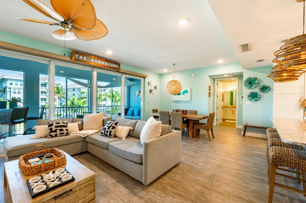 a living room with a couch and a table at Bungalow at Margaritaville! Less than 1 Mile to AMI! in Bradenton