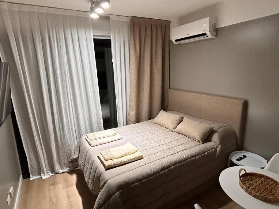 a small bedroom with a bed with towels on it at Departamento en Belgrano Capital Federal in Buenos Aires