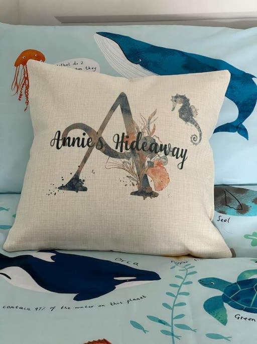 a pillow with the words mimika anniversary on a bed at Annie's Hideaway in Chapel Saint Leonards