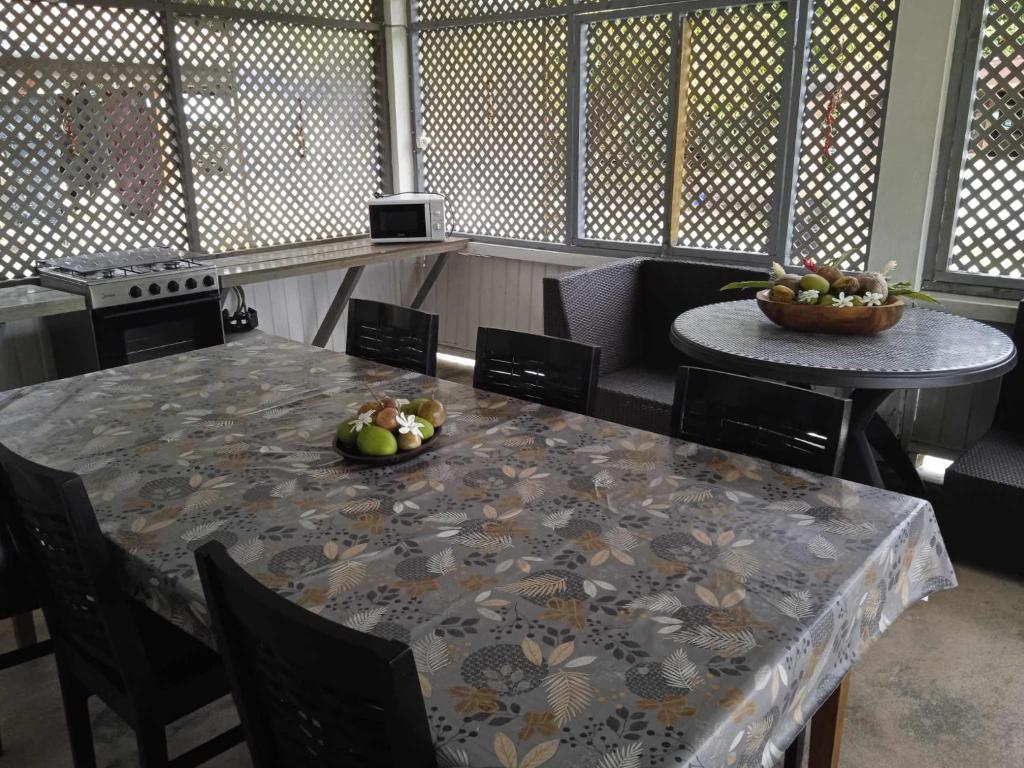 a dining room with a table with a bowl of fruit on it at Chez Angele in Faie
