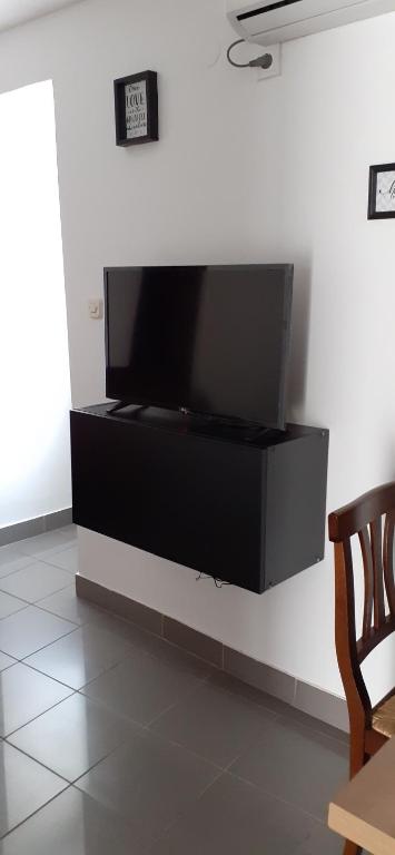 a large flat screen tv on a wall at Old Town Baska in Baška