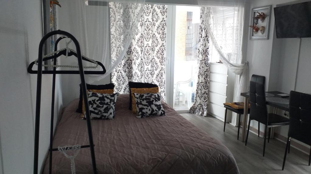sypialnia z łóżkiem, biurkiem i oknem w obiekcie Inlesa 5A Holiday apt with pool w mieście Benidorm