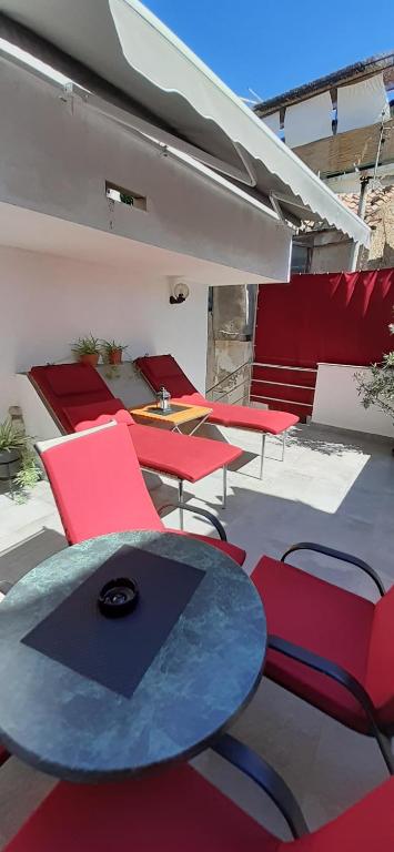 a group of chairs and a table in a room at Old Town Baska in Baška