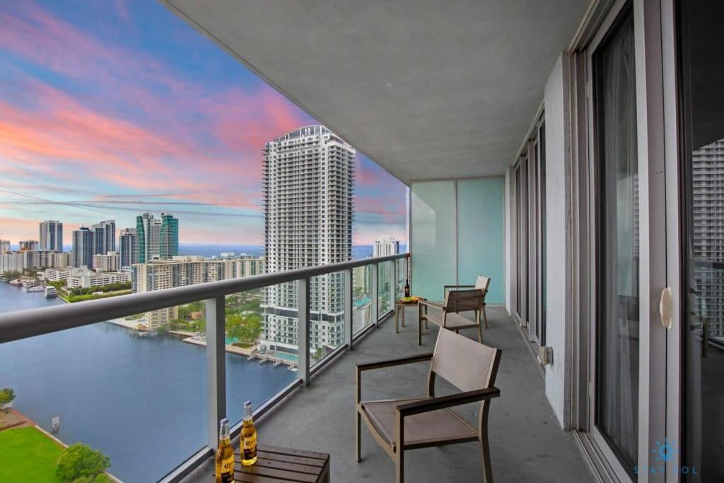 a balcony with chairs and a view of the city at Upper Beachwalk Condo Amazing Balcony View in Hallandale Beach