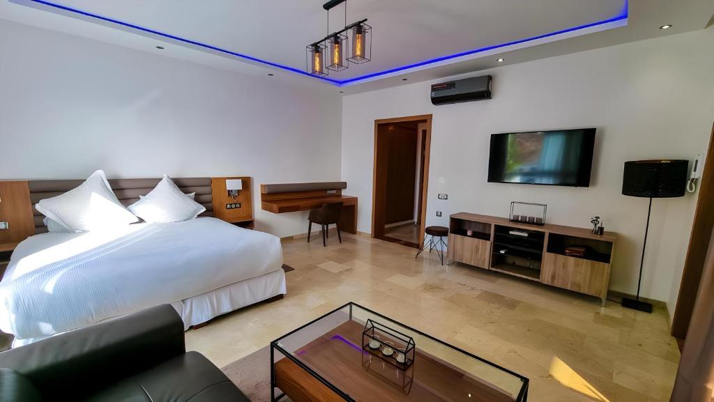 a hotel room with a bed and a tv at Appartement marina agadir in Agadir