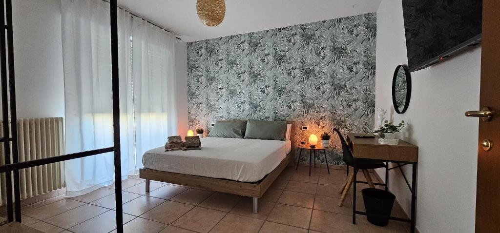 a bedroom with a bed and a desk with candles at Green House in Montesilvano