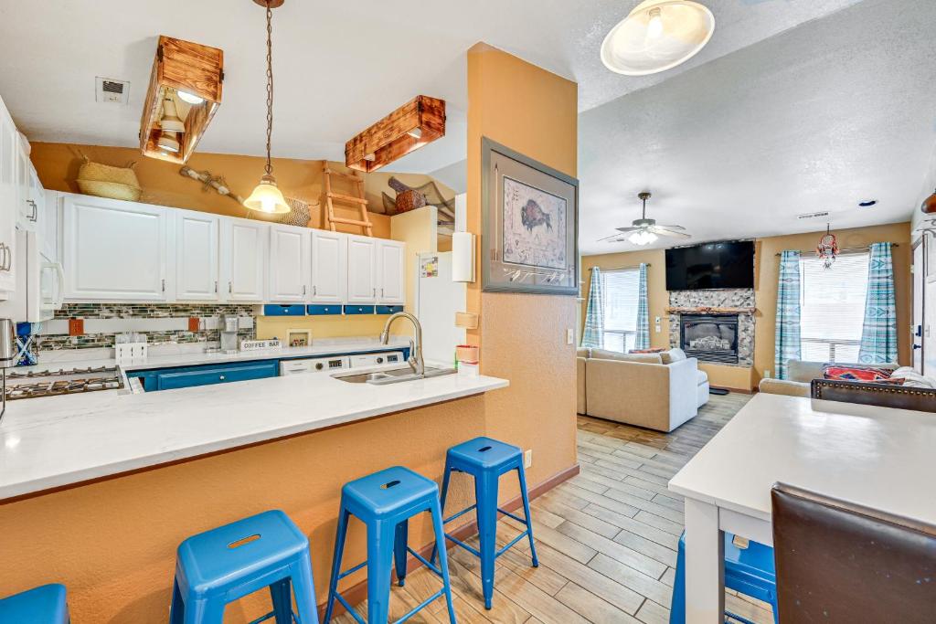 a kitchen with blue stools in front of a counter at Downtown Williams Home Walk to Shops and Dining! in Williams