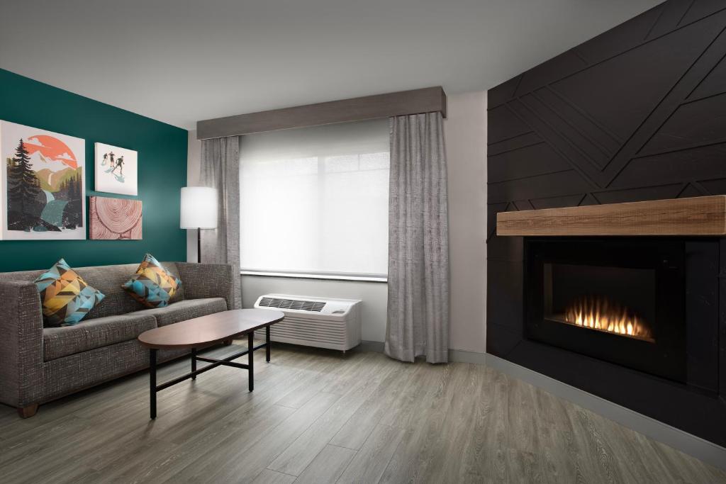 a living room with a couch and a fireplace at Holiday Inn & Suites Durango Downtown by IHG in Durango