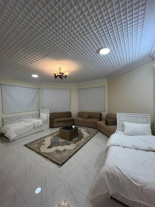 a living room with two beds and a couch at شقة غرفتين ومطبخ Apartment in Ar Rass