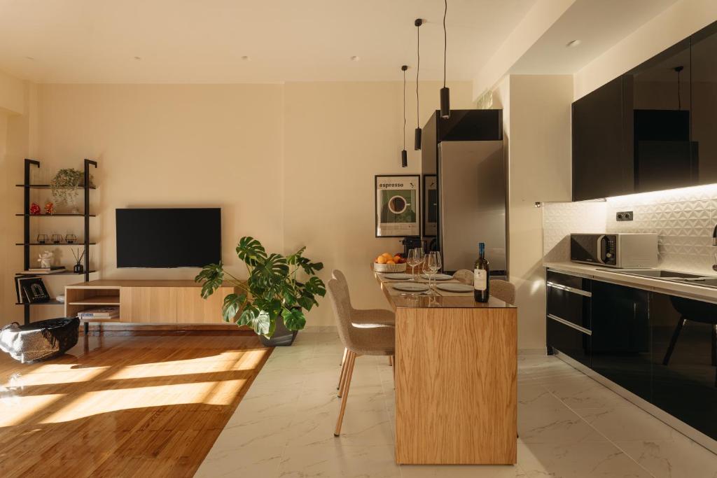 a kitchen with a table and a dining room at Patras Skyline Suite in Patra