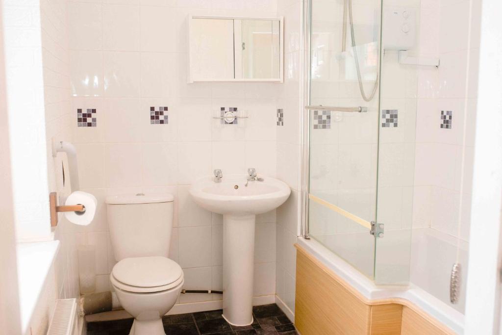 a bathroom with a toilet and a sink and a shower at THE CHADWICK in Skegness
