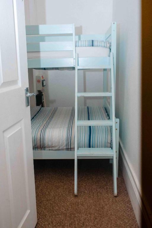 a white bunk bed with a ladder in a room at THE CHADWICK in Skegness