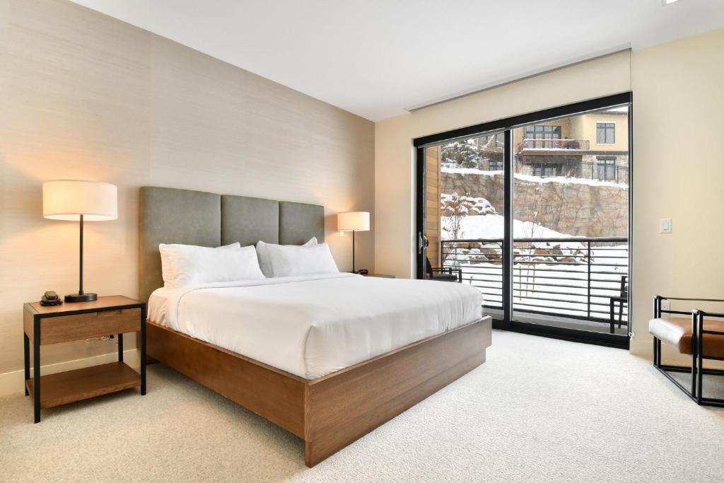 a bedroom with a bed and a large window at Lift Park City Condominiums in Park City