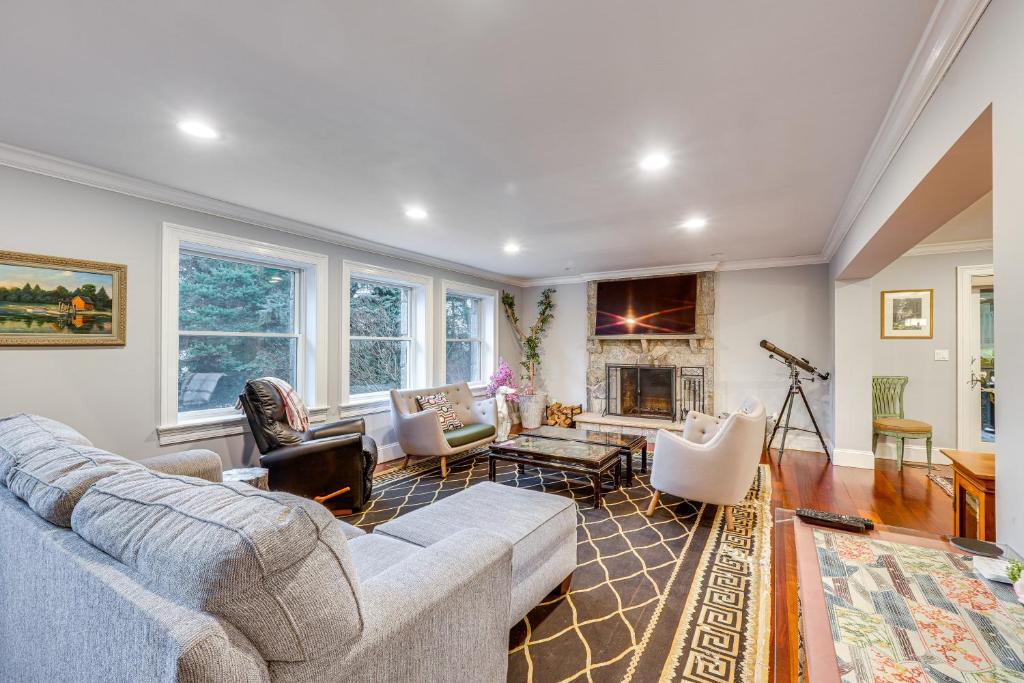 a living room with a couch and a fireplace at Briarcliff Manor Estate with Hudson River Views in Briarcliff Manor