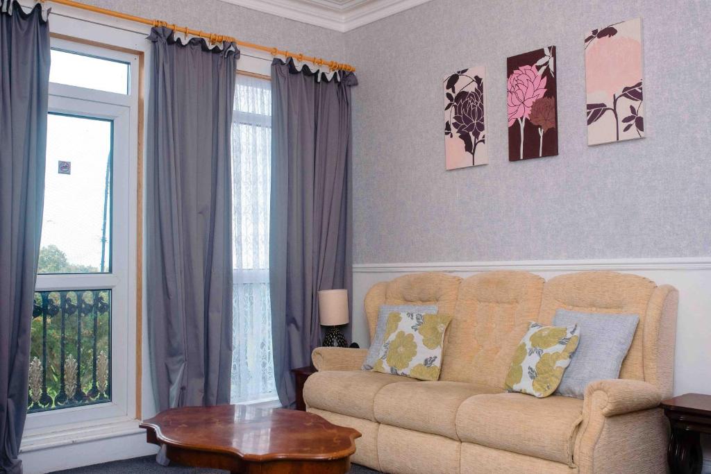 a living room with a couch and a window at THE CHADWICK in Skegness