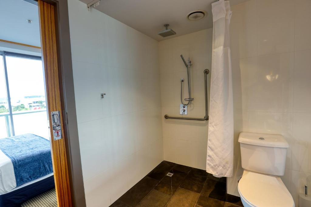 a bathroom with a toilet and a shower at Marsden Viaduct in Auckland