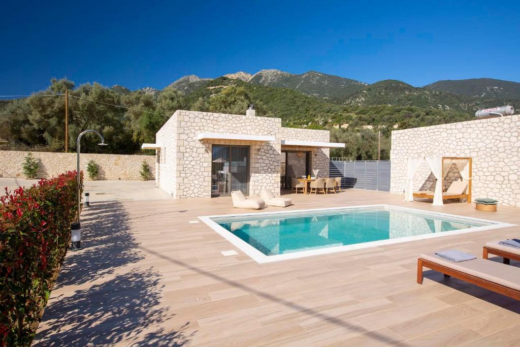 a villa with a swimming pool and a house at Christdilia villas in Palaiokatoúna