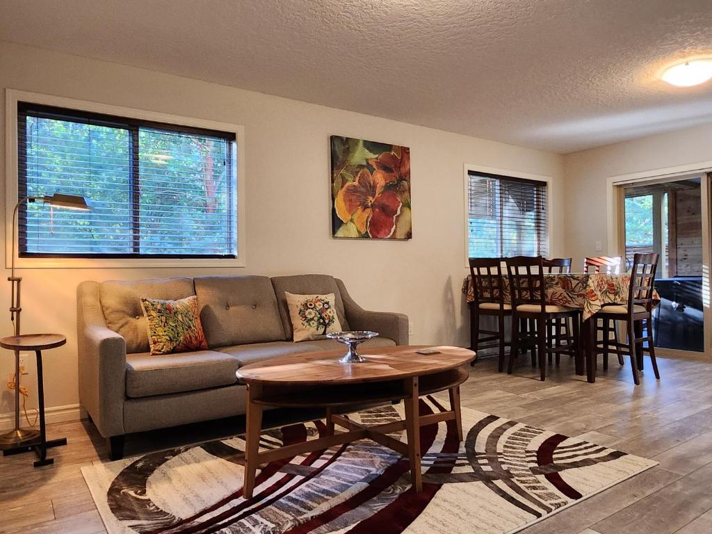 a living room with a couch and a table at Peaceful suite near the lake in Victoria