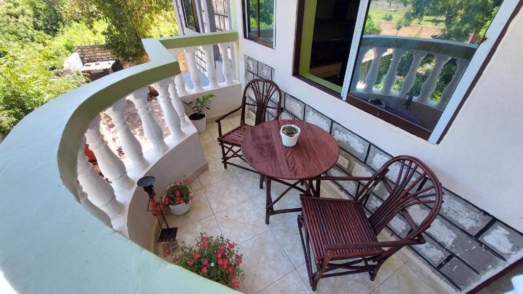 an overhead view of a table and chairs on a balcony at The Costal Sunny Daze,076 8976 732 in Mombasa