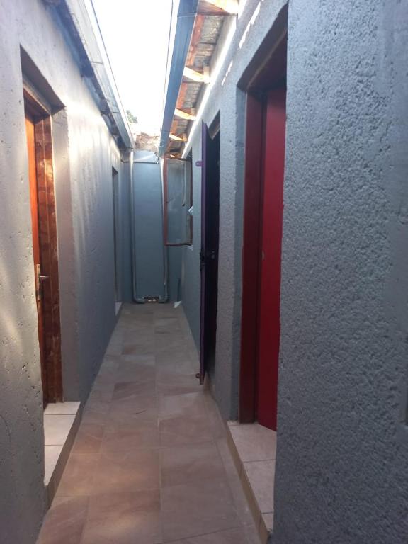 a hallway with two doors and a tile floor at Tanganani guest house in Doornrandjies