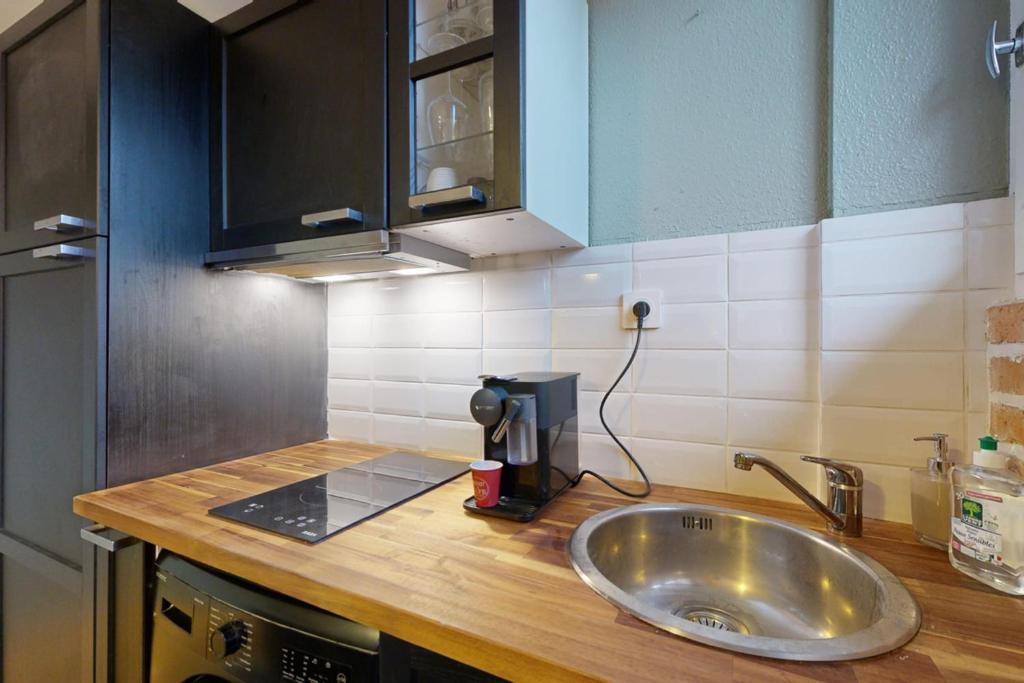 a kitchen counter with a sink and a coffee maker at LOVE ROOM with jacuzzi and beautiful terrace in Toulouse