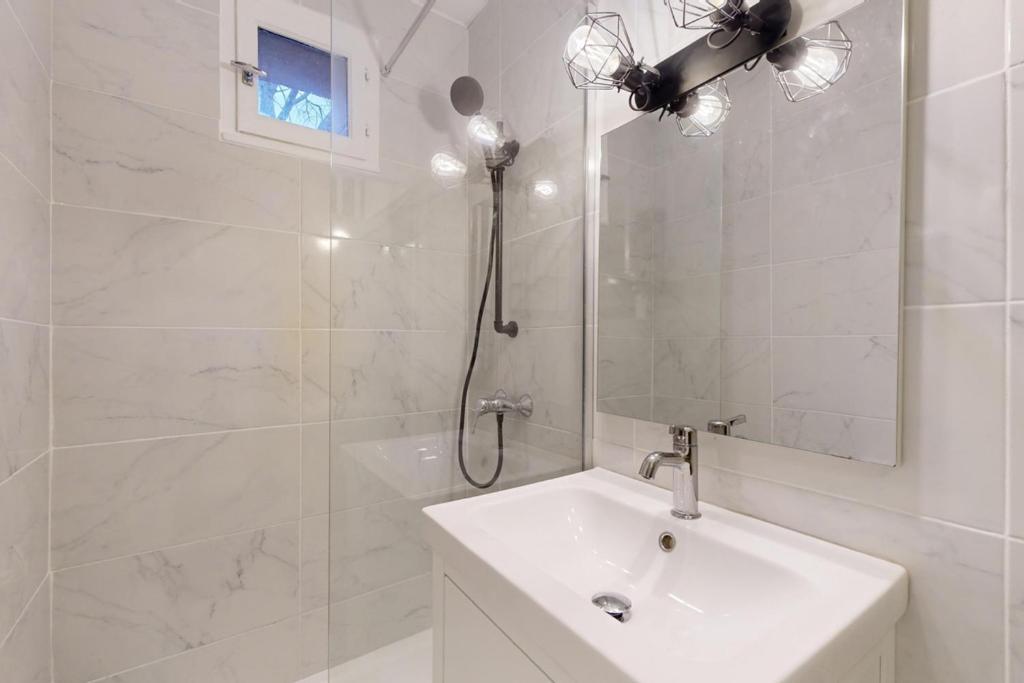 a white bathroom with a shower and a sink at LOVE ROOM with jacuzzi and beautiful terrace in Toulouse