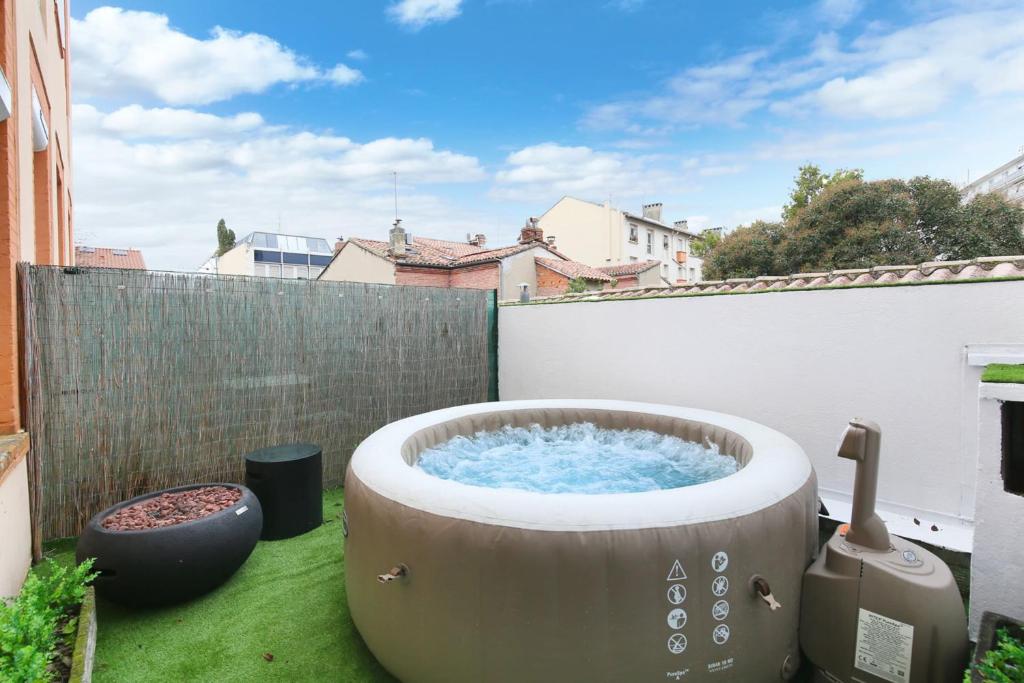 a hot tub on the back yard of a backyard at LOVE ROOM with jacuzzi and beautiful terrace in Toulouse