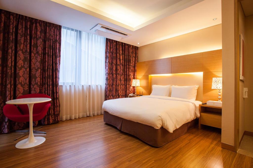 Postel nebo postele na pokoji v ubytování Hotel Pharos