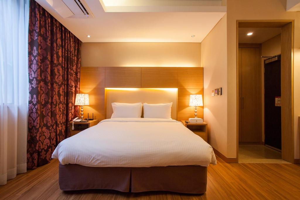 Postel nebo postele na pokoji v ubytování Hotel Pharos