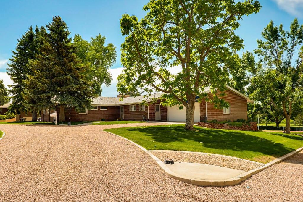 a house with a tree in the driveway at The 9th Green in Colorado Springs