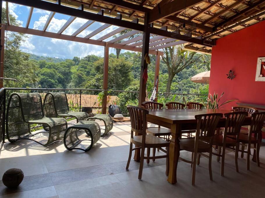 een eetkamer met een tafel en stoelen op een patio bij Villa Pietá in Brumadinho