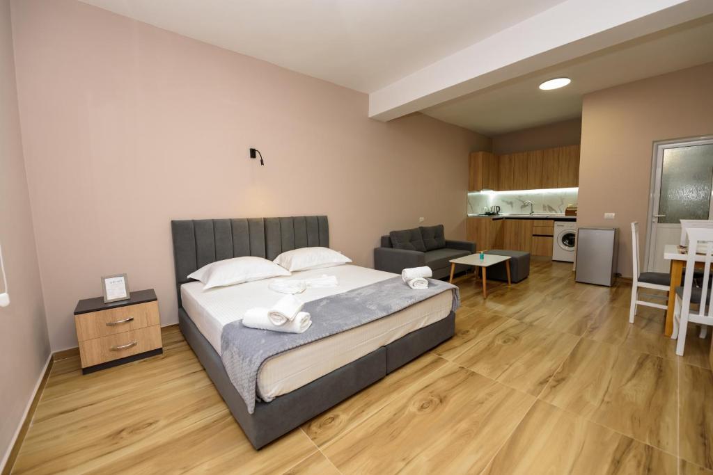 a bedroom with a bed and a living room at Mezani Guest House in Vlorë