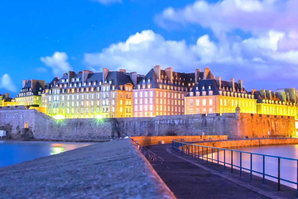 a large building next to a body of water at Nice cocoon in Saint-Malo in Saint Malo