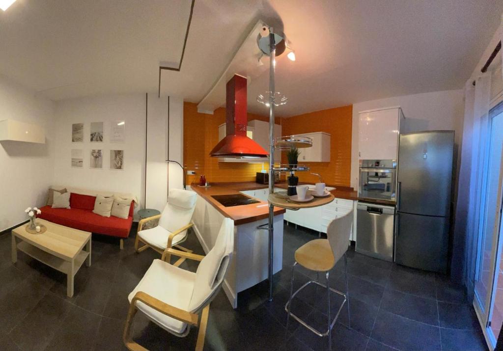 a kitchen with a table and chairs and a kitchen with a counter at Casa Pancho.Casita acogedora en Valencia in Valencia